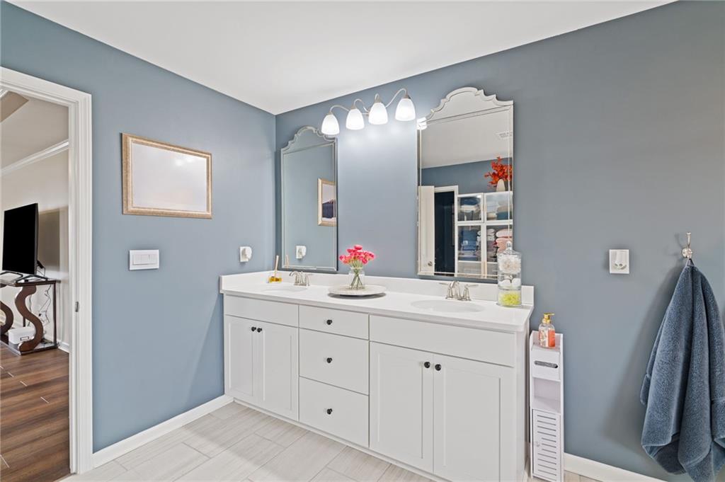 304 Ellenton Place Canton, GA 30115 - Photo 51 of 76 a bathroom with a double vanity sink and a mirror