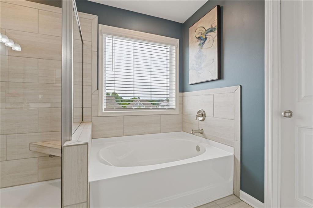 304 Ellenton Place Canton, GA 30115 - Photo 54 of 76 a white bath tub sitting next to a window