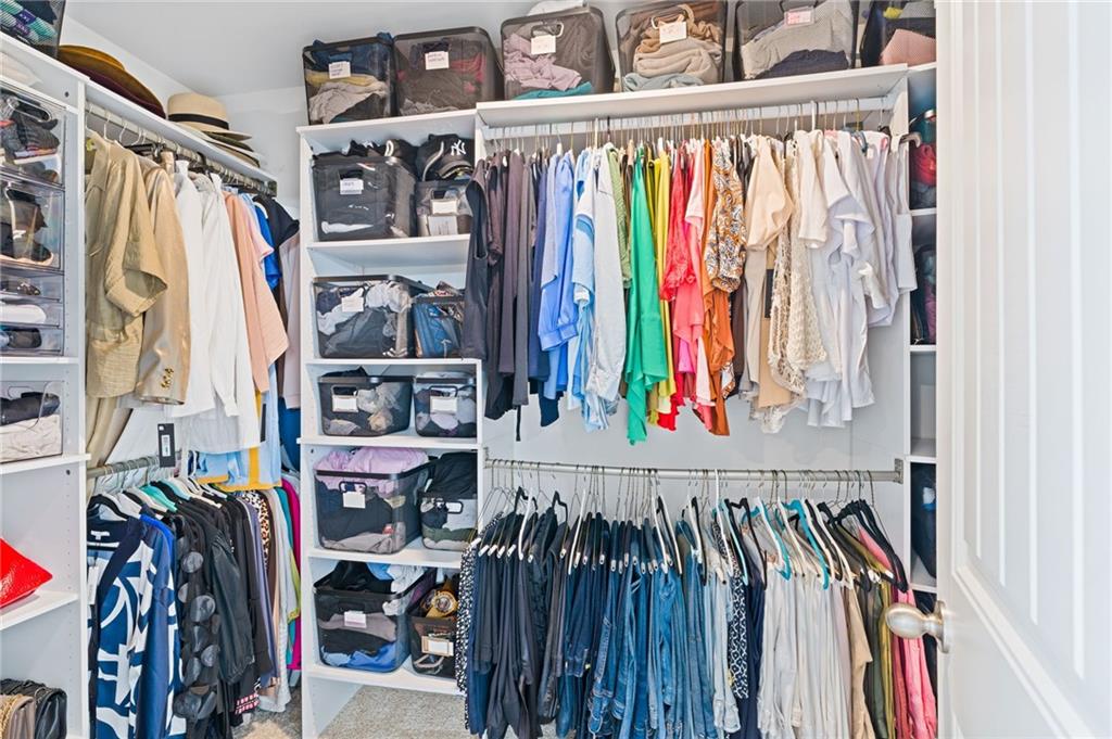304 Ellenton Place Canton, GA 30115 - Photo 55 of 76 a view of walk in closet with clothes