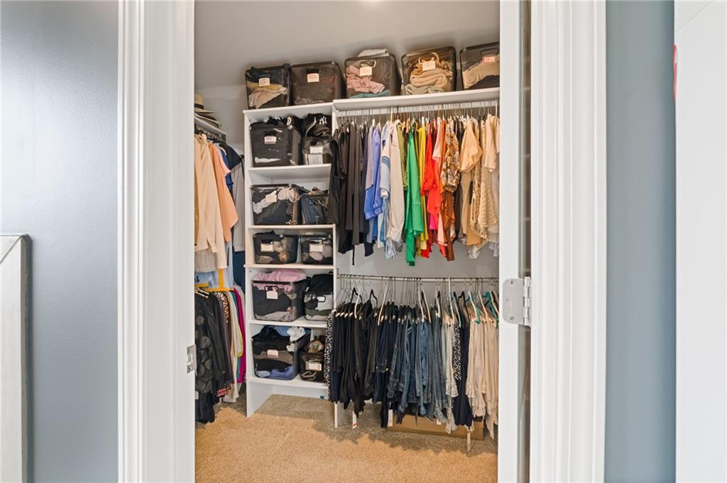 304 Ellenton Place Canton, GA 30115 - Photo 56 of 76 a view of walk in closet with clothes