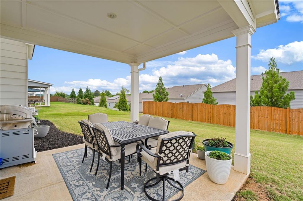 304 Ellenton Place Canton, GA 30115 - Photo 58 of 76 a view of a patio with a table and chairs and potted plants