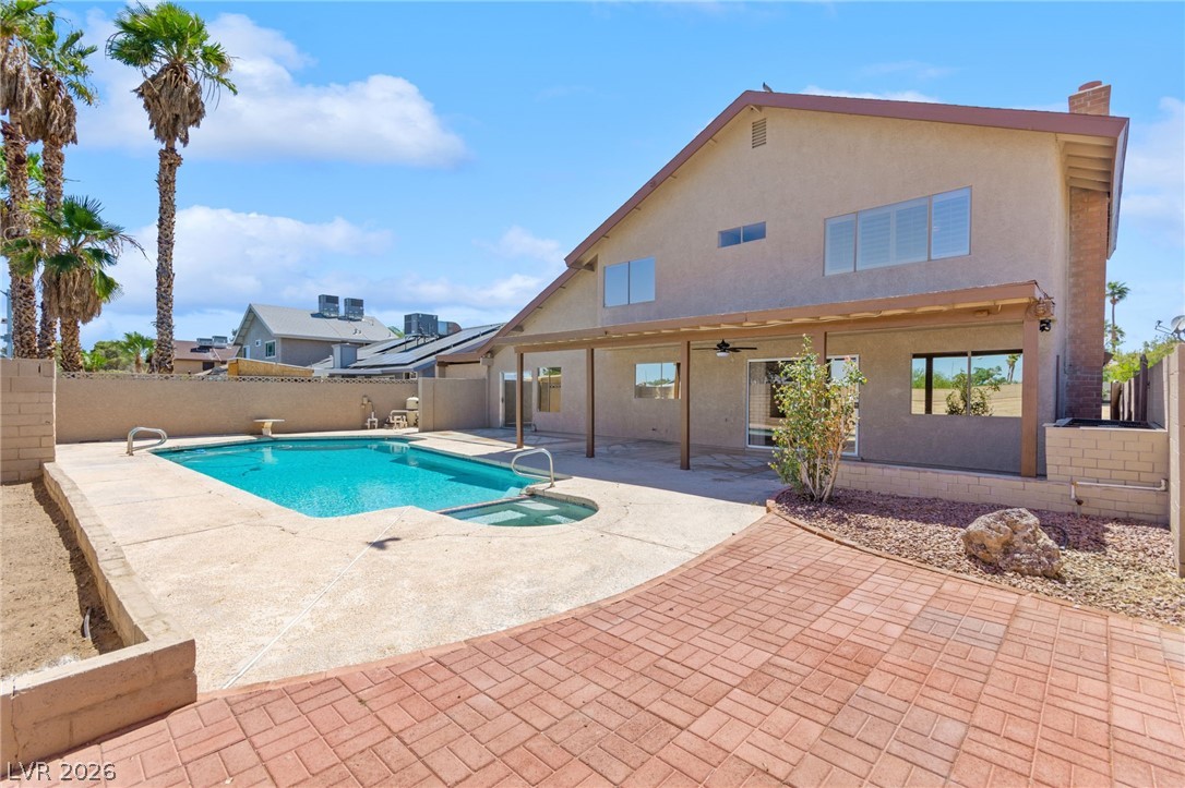 4430 Cranbrook Way Las Vegas, NV 89103 - Photo 20 of 50 A spacious backyard retreat features a refreshing pool, ample patio space, and mature palm trees.