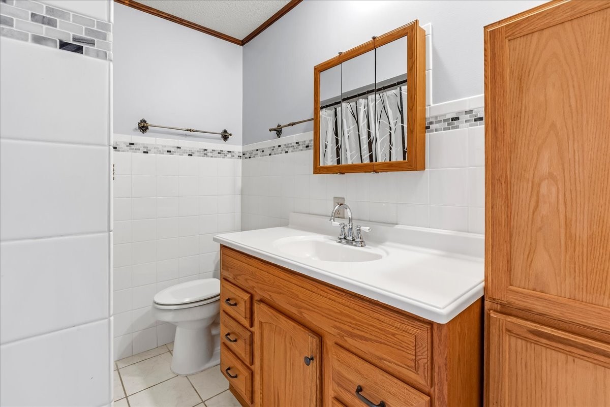 300 Marbeth Lane Tullahoma, TN 37388 - Photo 43 of 50 a bathroom with a granite countertop sink toilet a mirror and shower