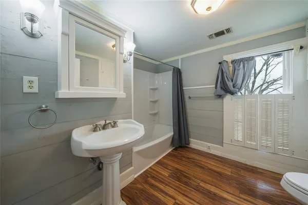 a bathroom with a sink a mirror and shower