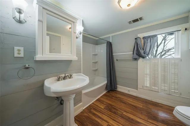 a bathroom with a sink a mirror and shower