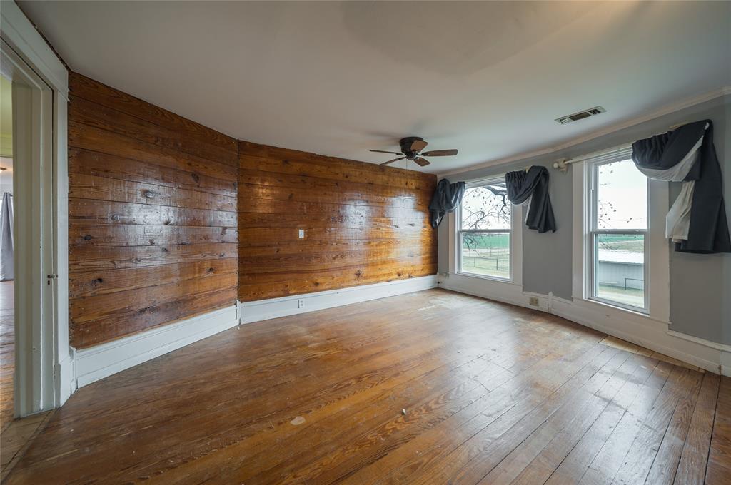 101 South Jacob Lane Winters, TX 79567 - Photo 16 of 38 a view of empty room with wooden floor and fan