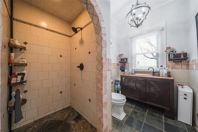 a bathroom with a toilet a sink and shower