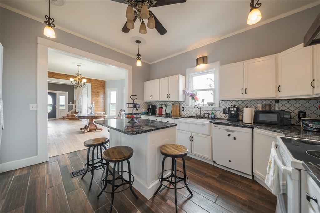 101 South Jacob Lane Winters, TX 79567 - Photo 2 of 38 a kitchen with stainless steel appliances a table chairs refrigerator and cabinets