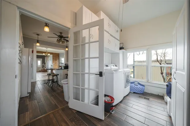 a very nice looking room with wooden floor and furniture