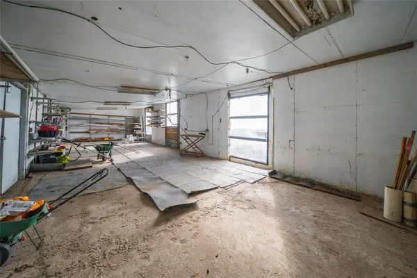 a view of a backyard with lawn chairs fire pit and wooden fence
