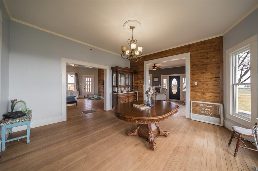101 South Jacob Lane Winters, TX 79567 - Photo 5 of 38 a dining room with wooden floor and a chandelier