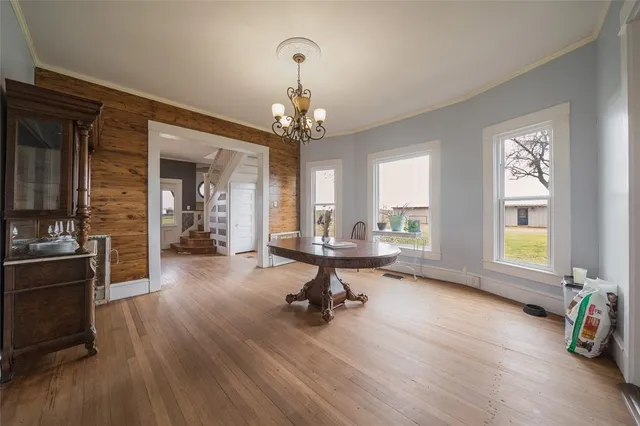 a view of a livingroom with kitchen and hardwood floor