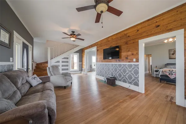 a living room with furniture and a chandelier
