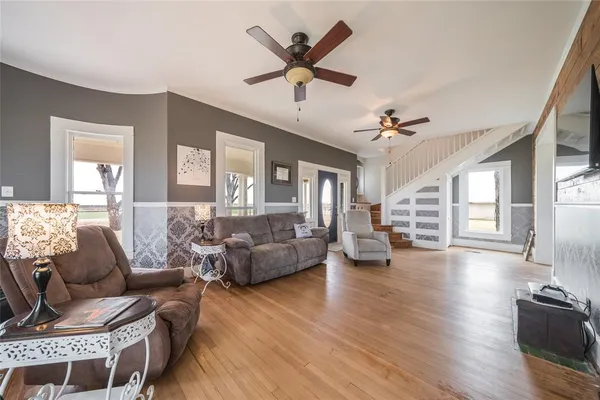 a living room with furniture and a large window