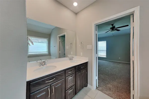 a bathroom with a sink double vanity and a mirror