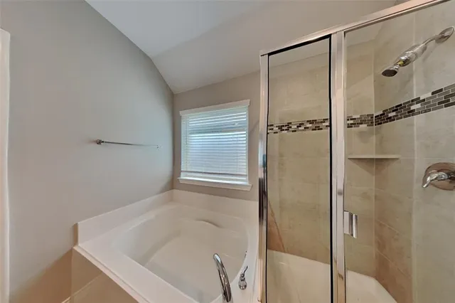 a bathroom with a tub and a shower