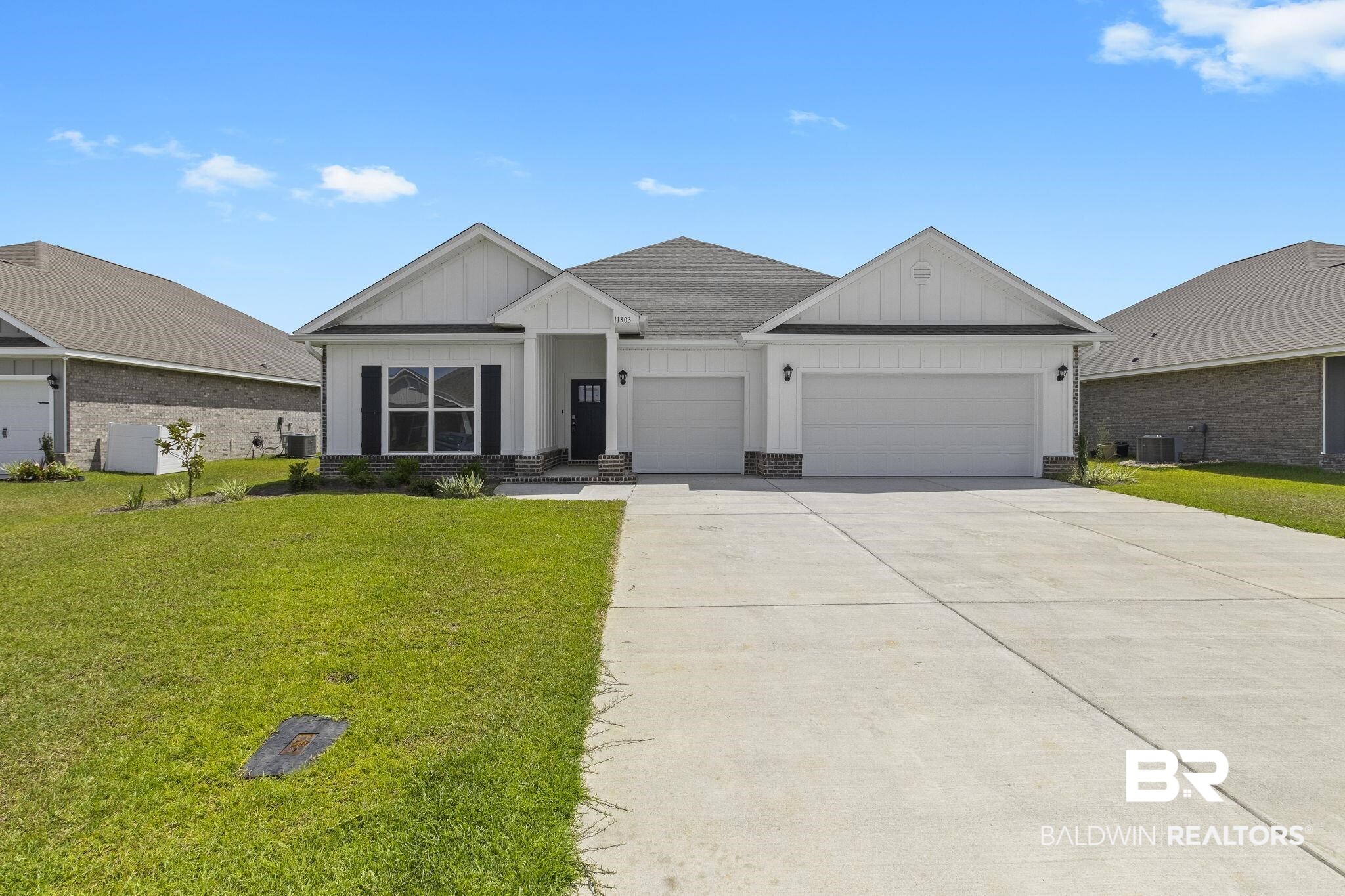 11303 Genuine Risk Circle Daphne, AL 36526 - Photo 2 of 100 View of front of home with a front lawn, central air condition unit, and a garage