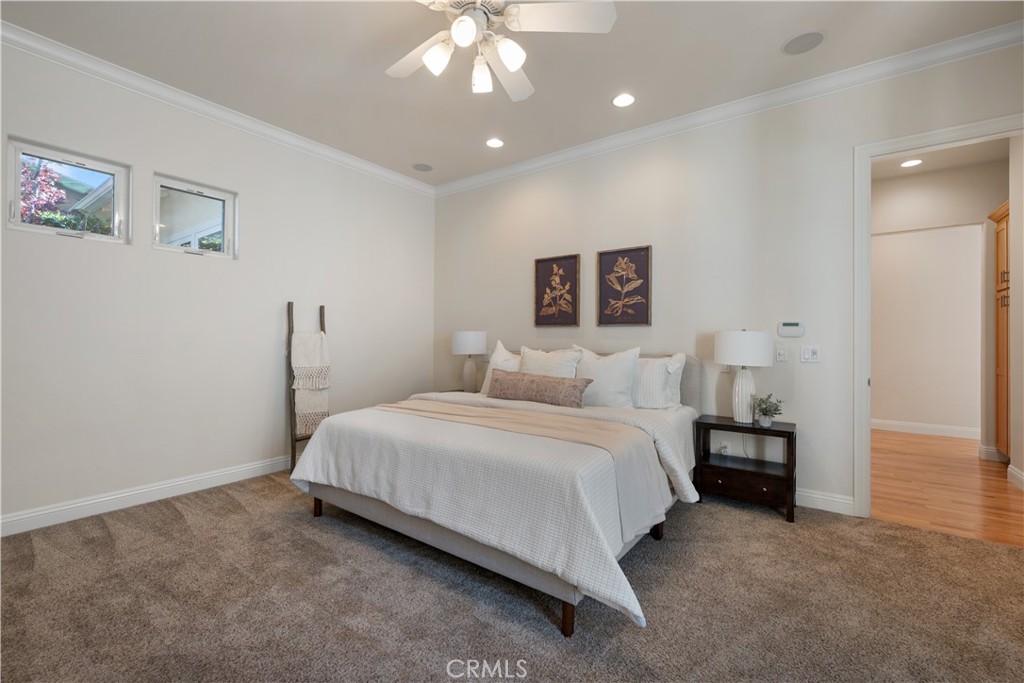 920 Wigeon Way Arroyo Grande, CA 93420 - Photo 16 of 57 a spacious bedroom with a bed and a chandelier