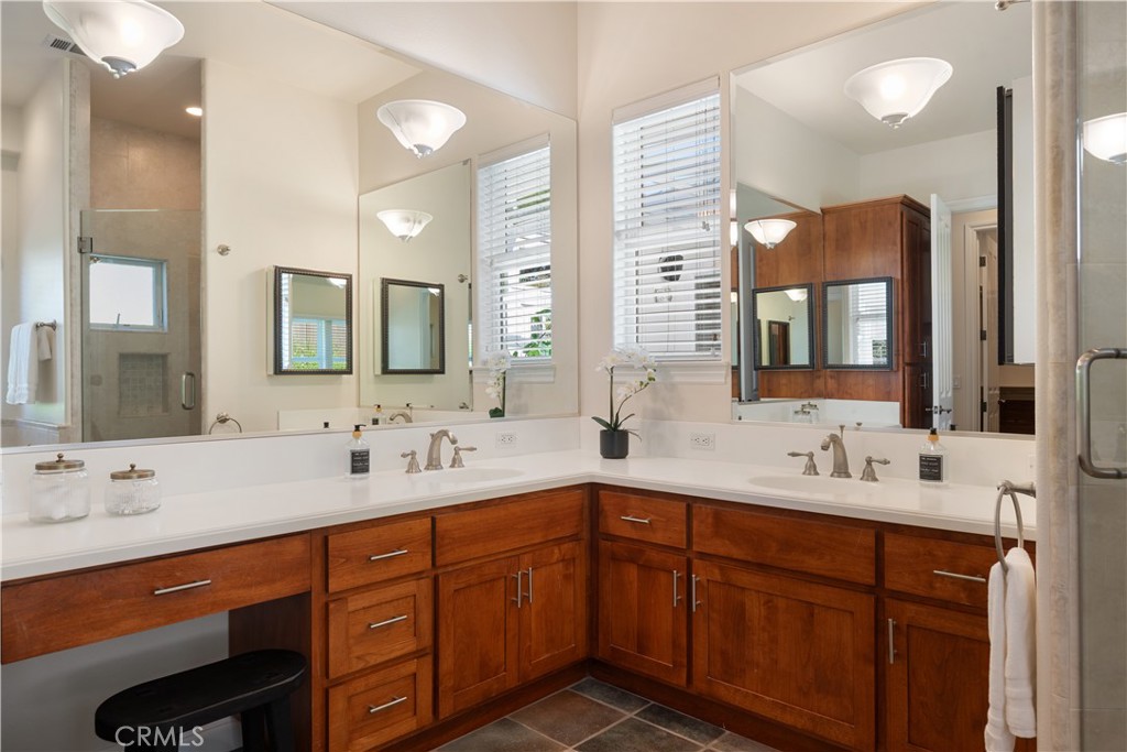 920 Wigeon Way Arroyo Grande, CA 93420 - Photo 22 of 57 a bathroom with a double vanity sink and mirror