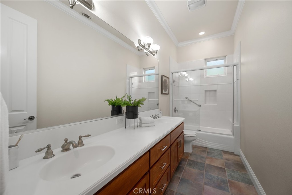 920 Wigeon Way Arroyo Grande, CA 93420 - Photo 27 of 57 a bathroom with a double vanity sink and a mirror