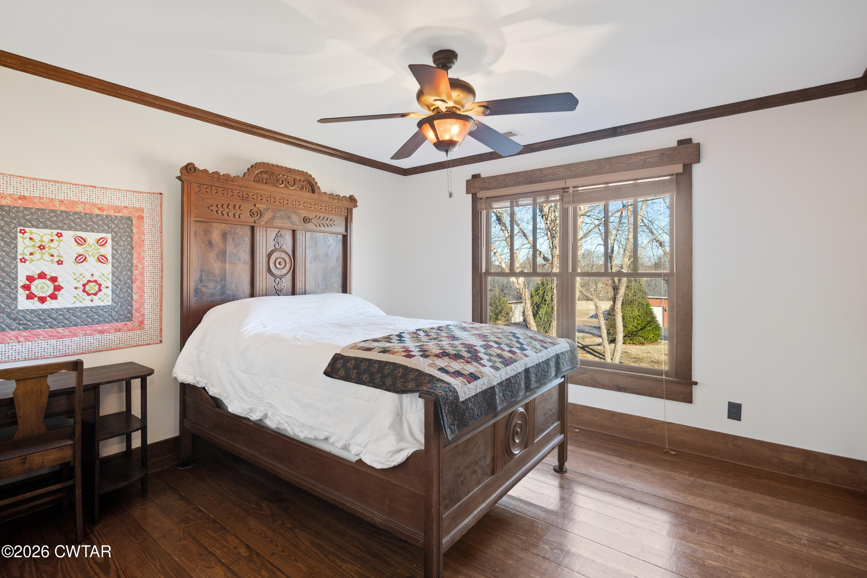 117 Pleasant Hill Road Humboldt, TN 38343 - Photo 25 of 45 a bedroom with a bed and a chandelier
