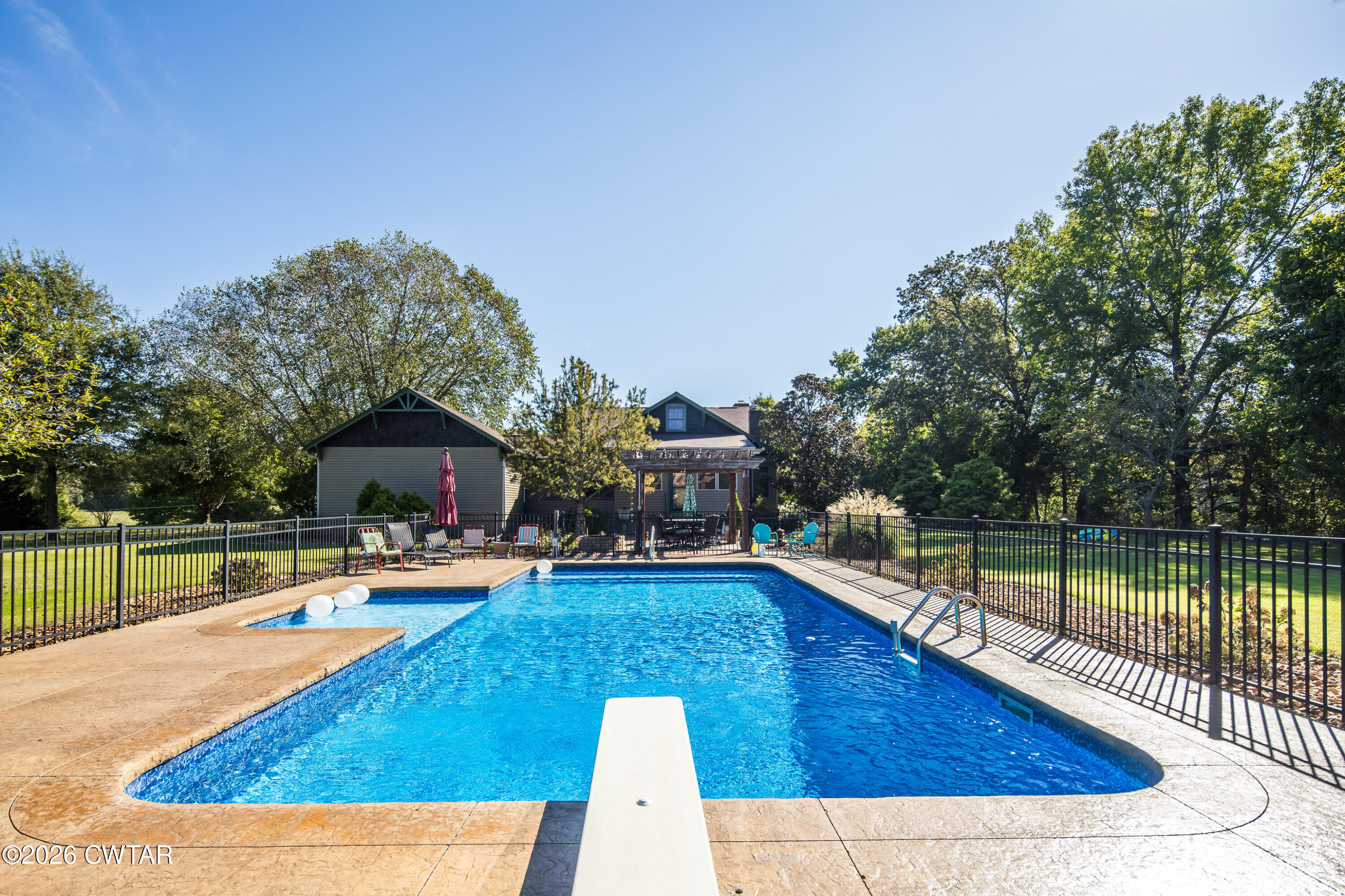 117 Pleasant Hill Road Humboldt, TN 38343 - Photo 29 of 45 a view of a swimming pool with a lounge chair