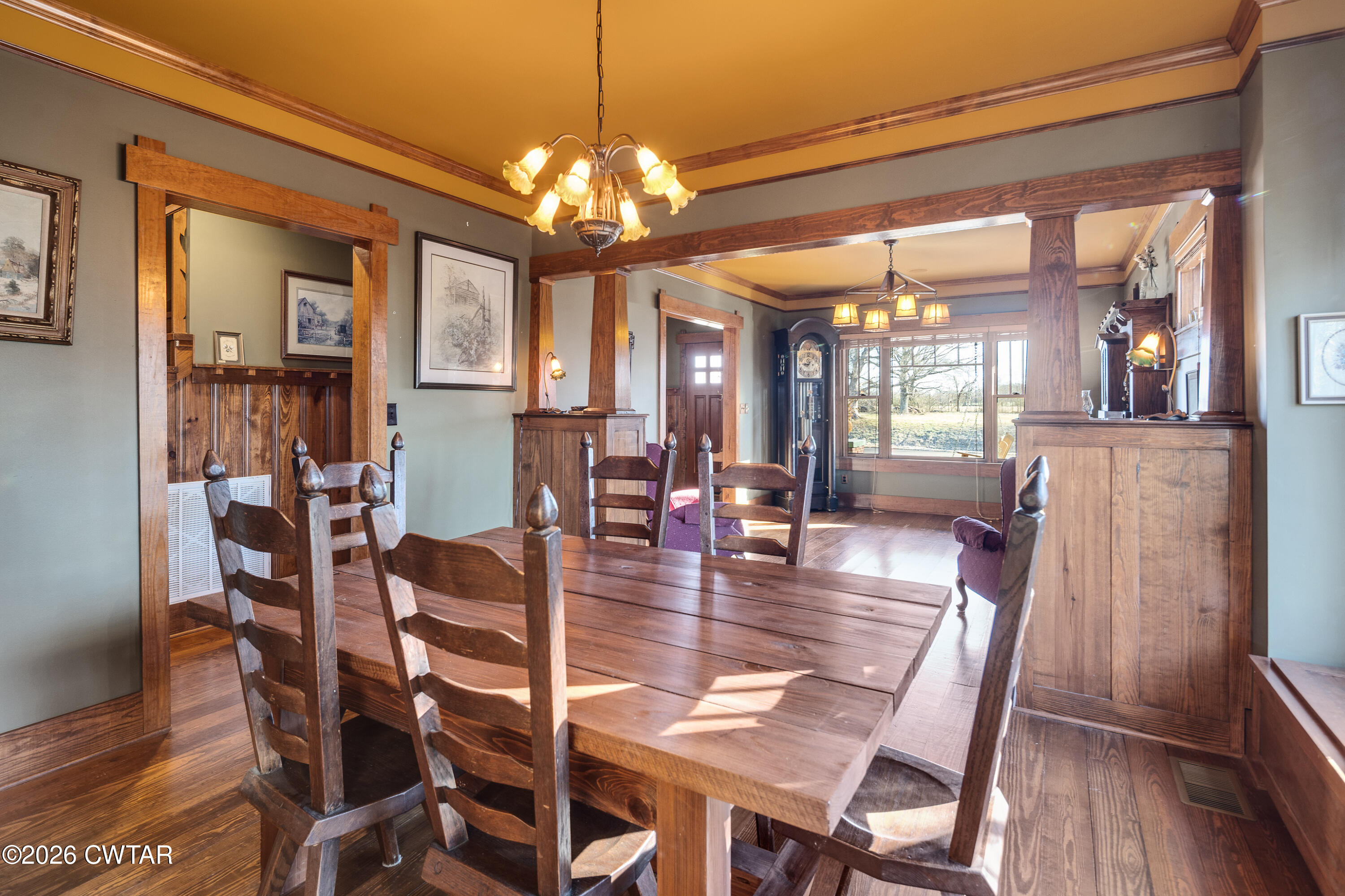 117 Pleasant Hill Road Humboldt, TN 38343 - Photo 8 of 45 a dining room with wooden floor a chandelier a wooden table and chairs