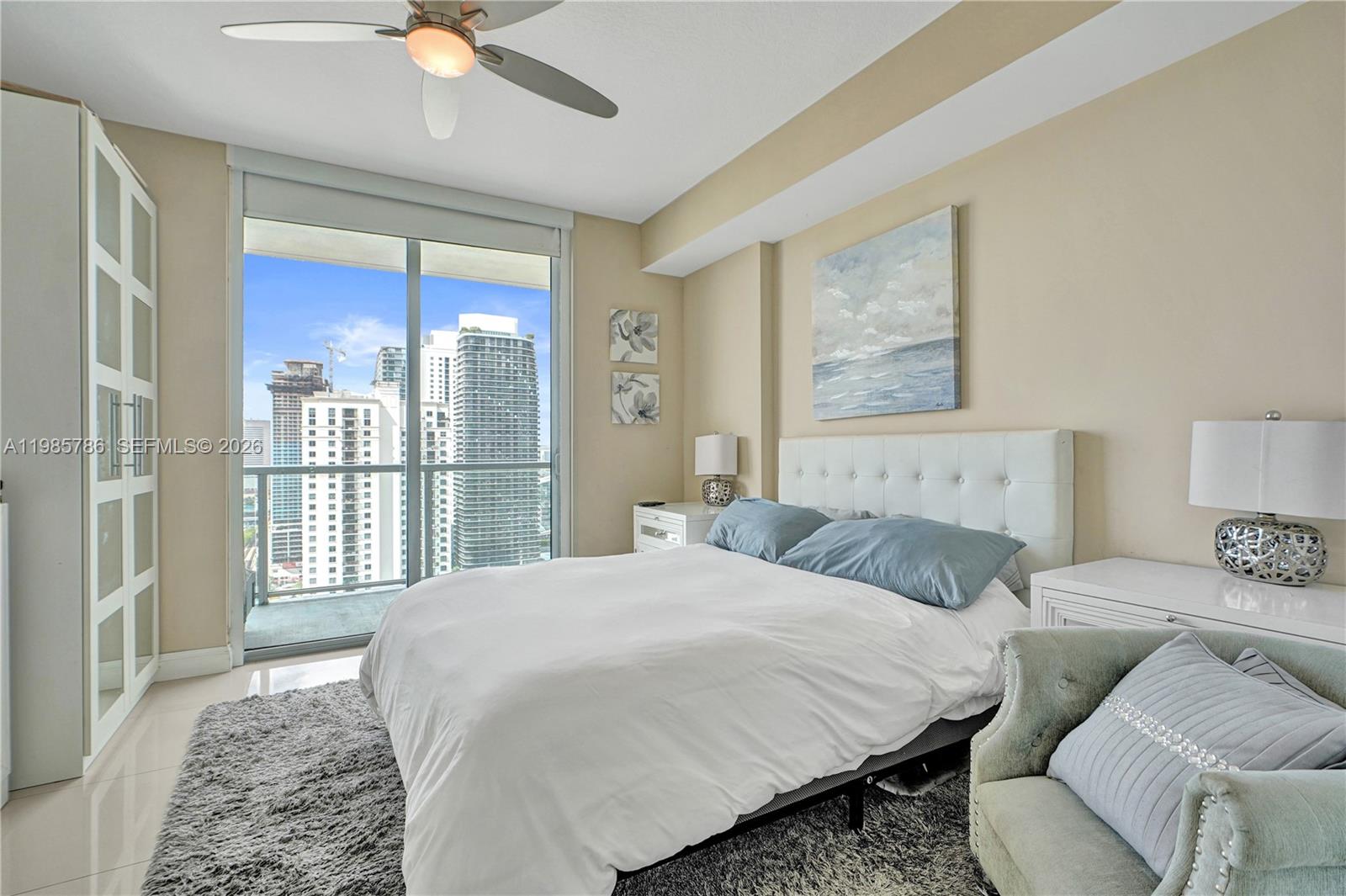 79 Southwest 12th Street, Unit 3412S Miami, FL 33130 - Photo 11 of 37 a bedroom with a large bed and a couch