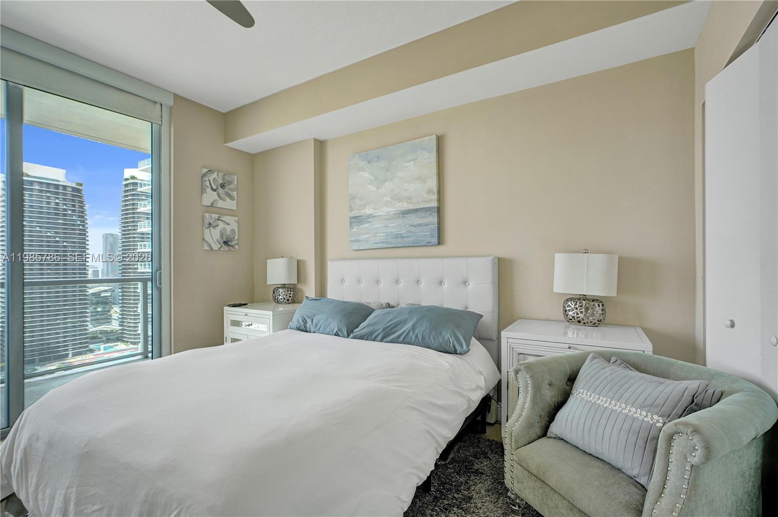 79 Southwest 12th Street, Unit 3412S Miami, FL 33130 - Photo 12 of 37 a bedroom with a bed and glass window