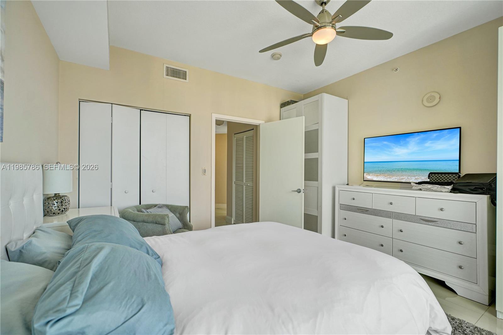 79 Southwest 12th Street, Unit 3412S Miami, FL 33130 - Photo 14 of 37 a bedroom with a bed and a flat screen tv