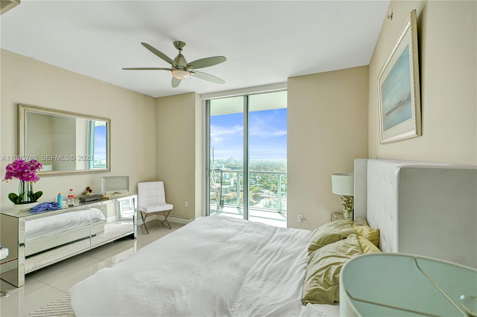 79 Southwest 12th Street, Unit 3412S Miami, FL 33130 - Photo 17 of 37 a bedroom with a bed and ceiling fan