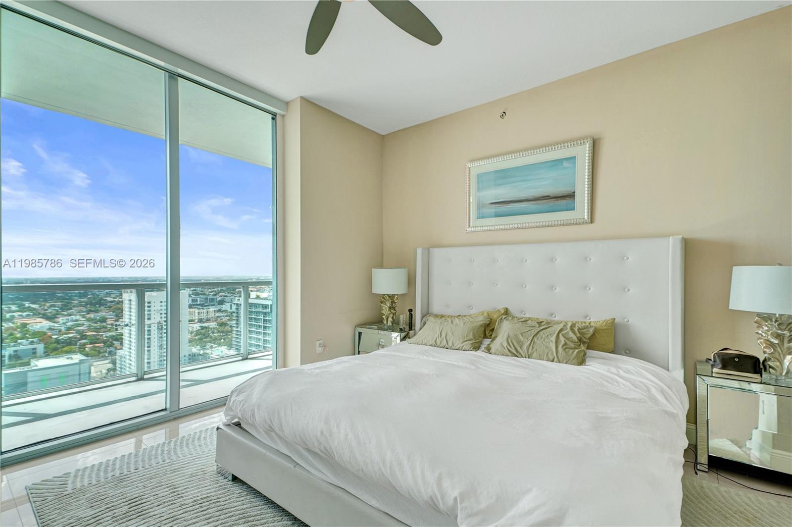 79 Southwest 12th Street, Unit 3412S Miami, FL 33130 - Photo 19 of 37 a bedroom with a large bed and a large window