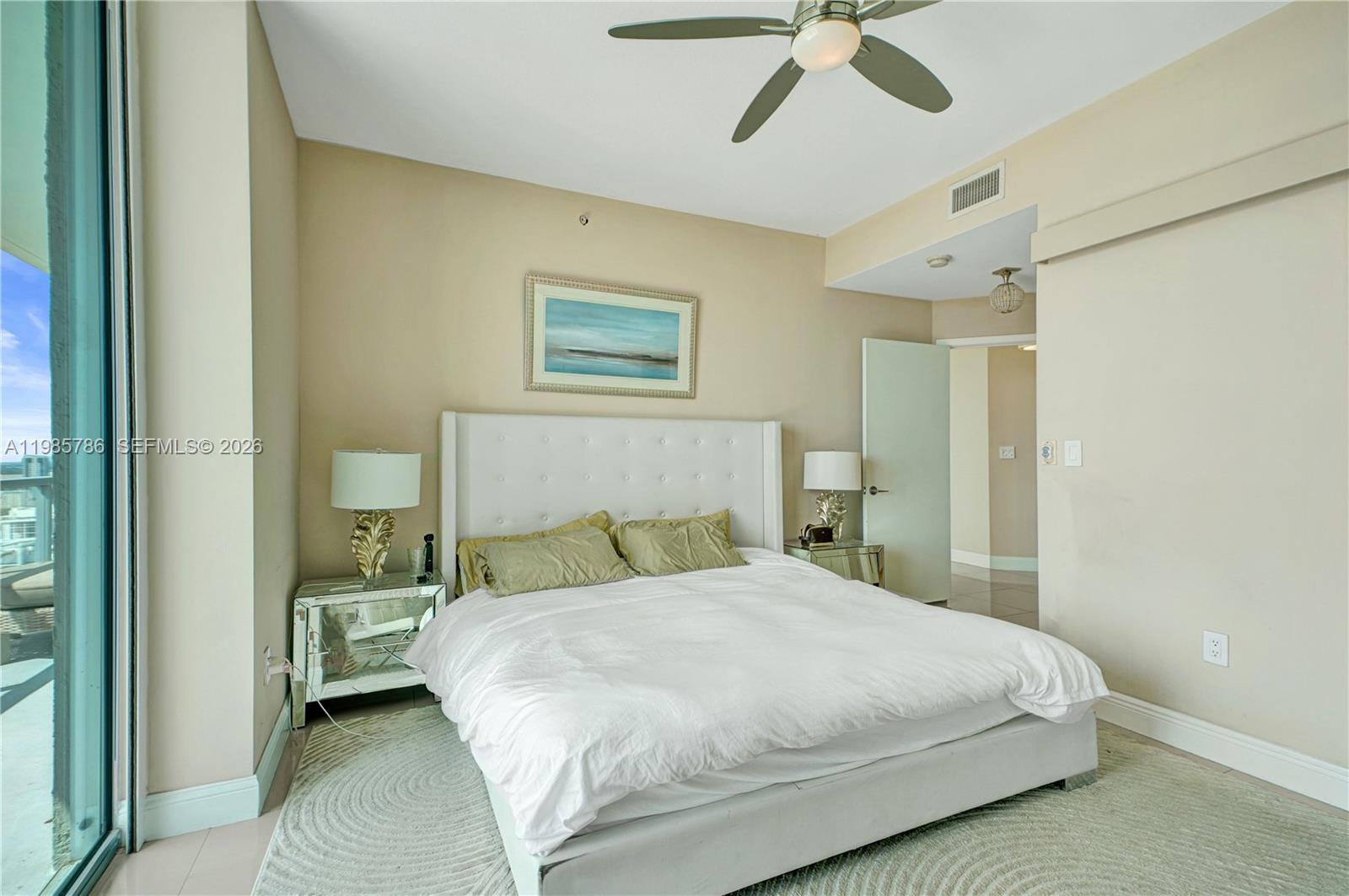 79 Southwest 12th Street, Unit 3412S Miami, FL 33130 - Photo 20 of 37 a bedroom with a bed and a ceiling fan