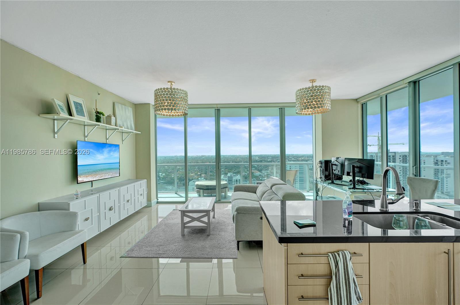 79 Southwest 12th Street, Unit 3412S Miami, FL 33130 - Photo 2 of 37 a very nice looking living room with a large window and a flat screen tv