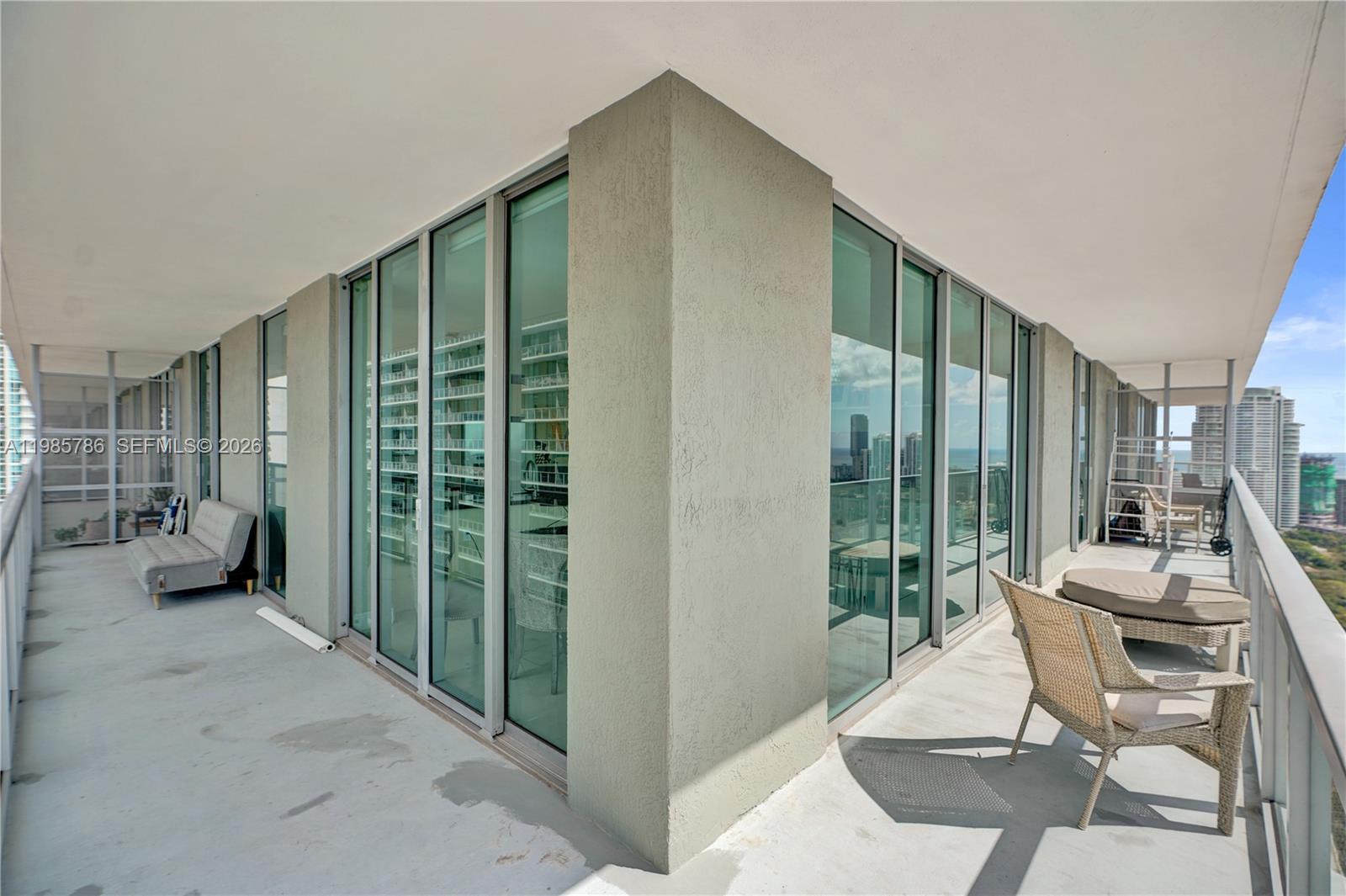 79 Southwest 12th Street, Unit 3412S Miami, FL 33130 - Photo 27 of 37 a balcony with couple of chairs and a couch