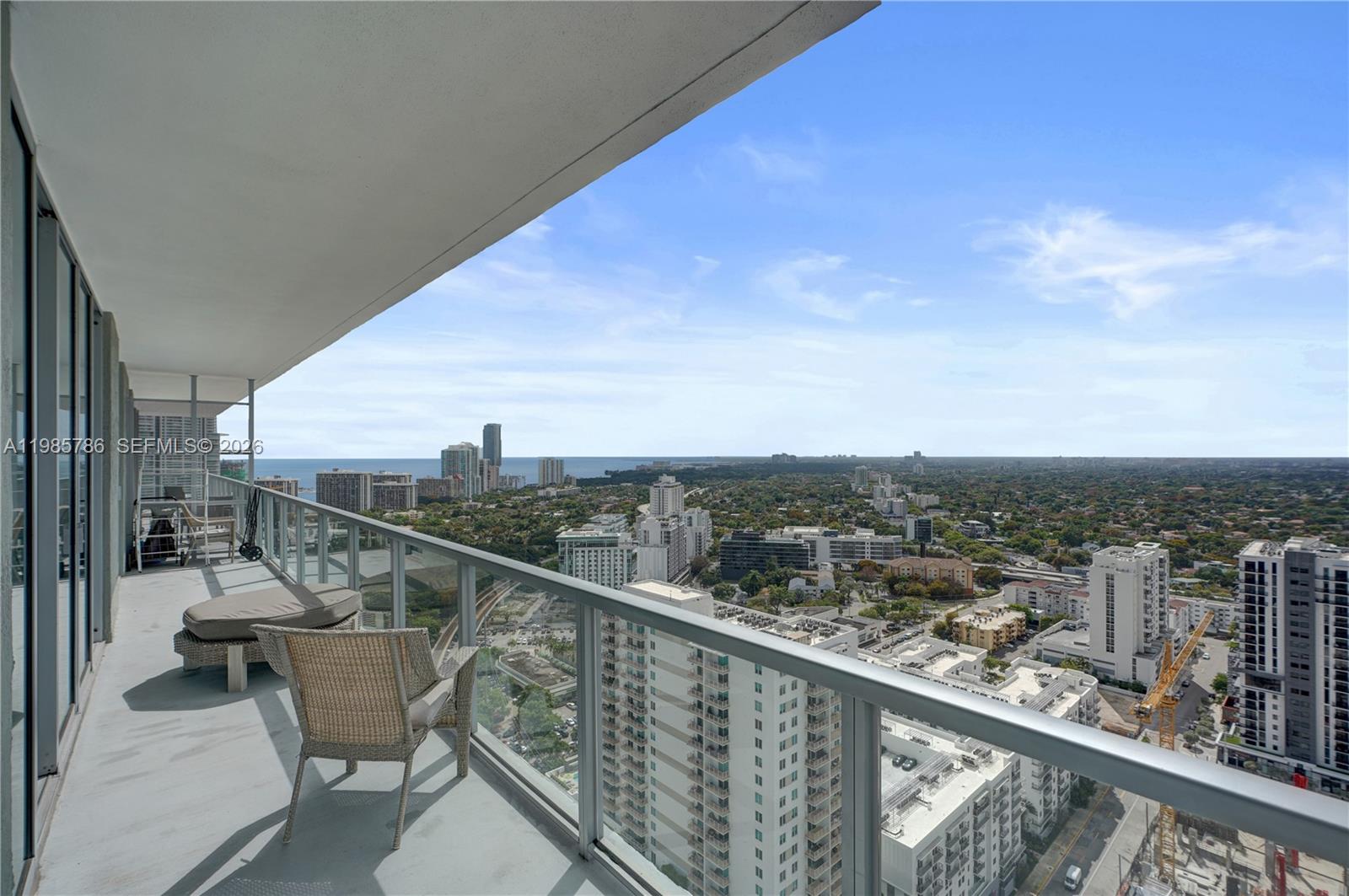79 Southwest 12th Street, Unit 3412S Miami, FL 33130 - Photo 37 of 37 a view of a balcony with chairs