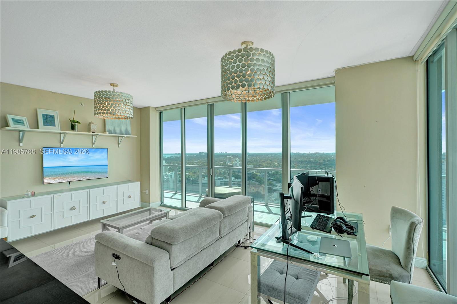 79 Southwest 12th Street, Unit 3412S Miami, FL 33130 - Photo 4 of 37 a living room with furniture and a floor to ceiling window