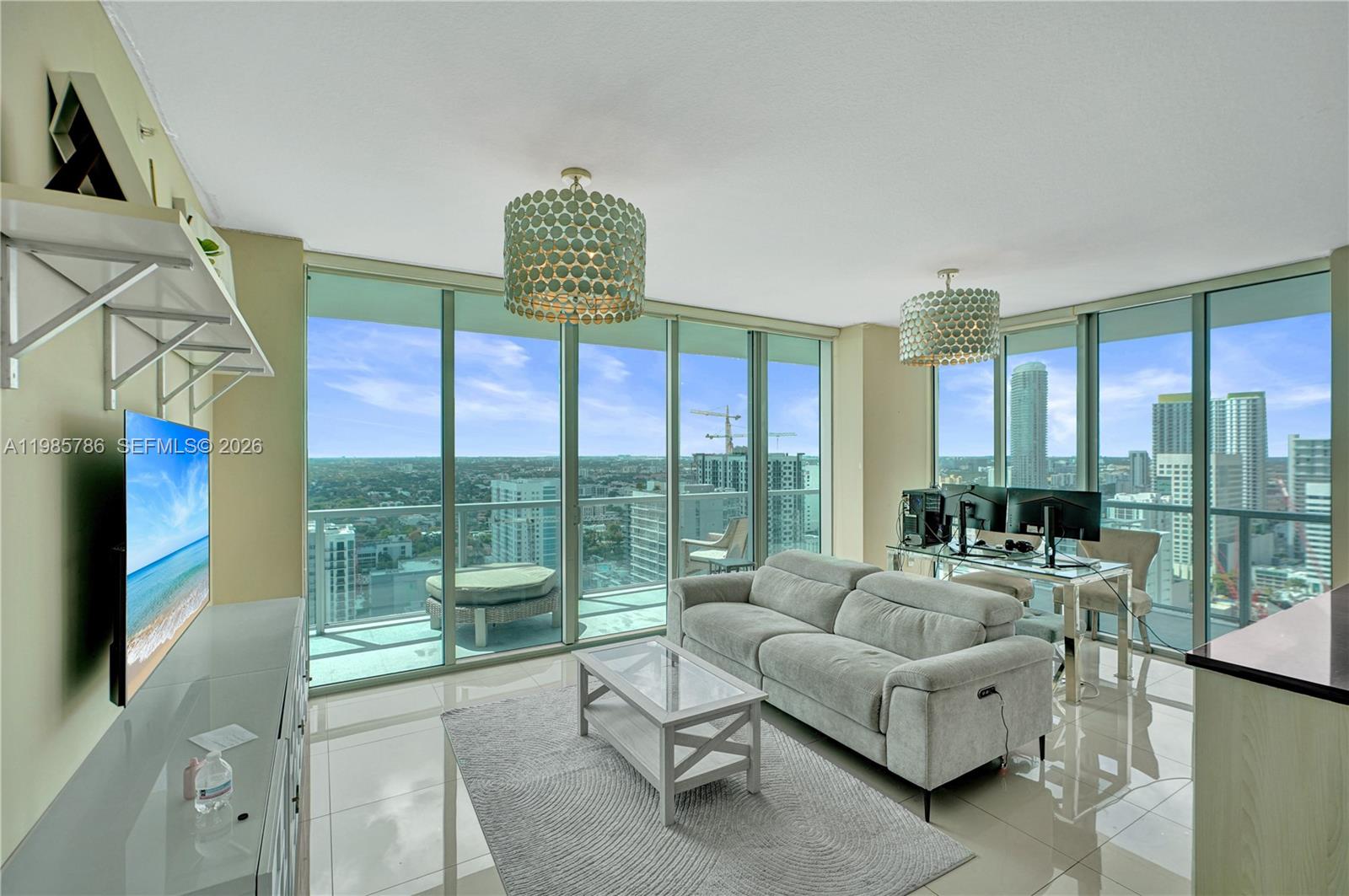 79 Southwest 12th Street, Unit 3412S Miami, FL 33130 - Photo 5 of 37 a living room with furniture and a floor to ceiling window