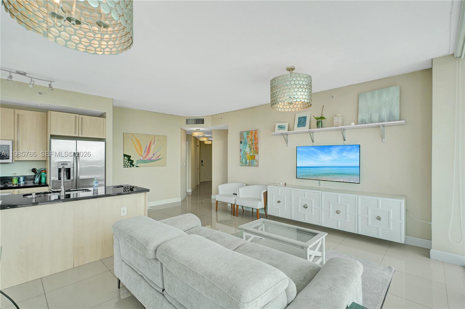79 Southwest 12th Street, Unit 3412S Miami, FL 33130 - Photo 7 of 37 a large bedroom with a bed and a chandelier