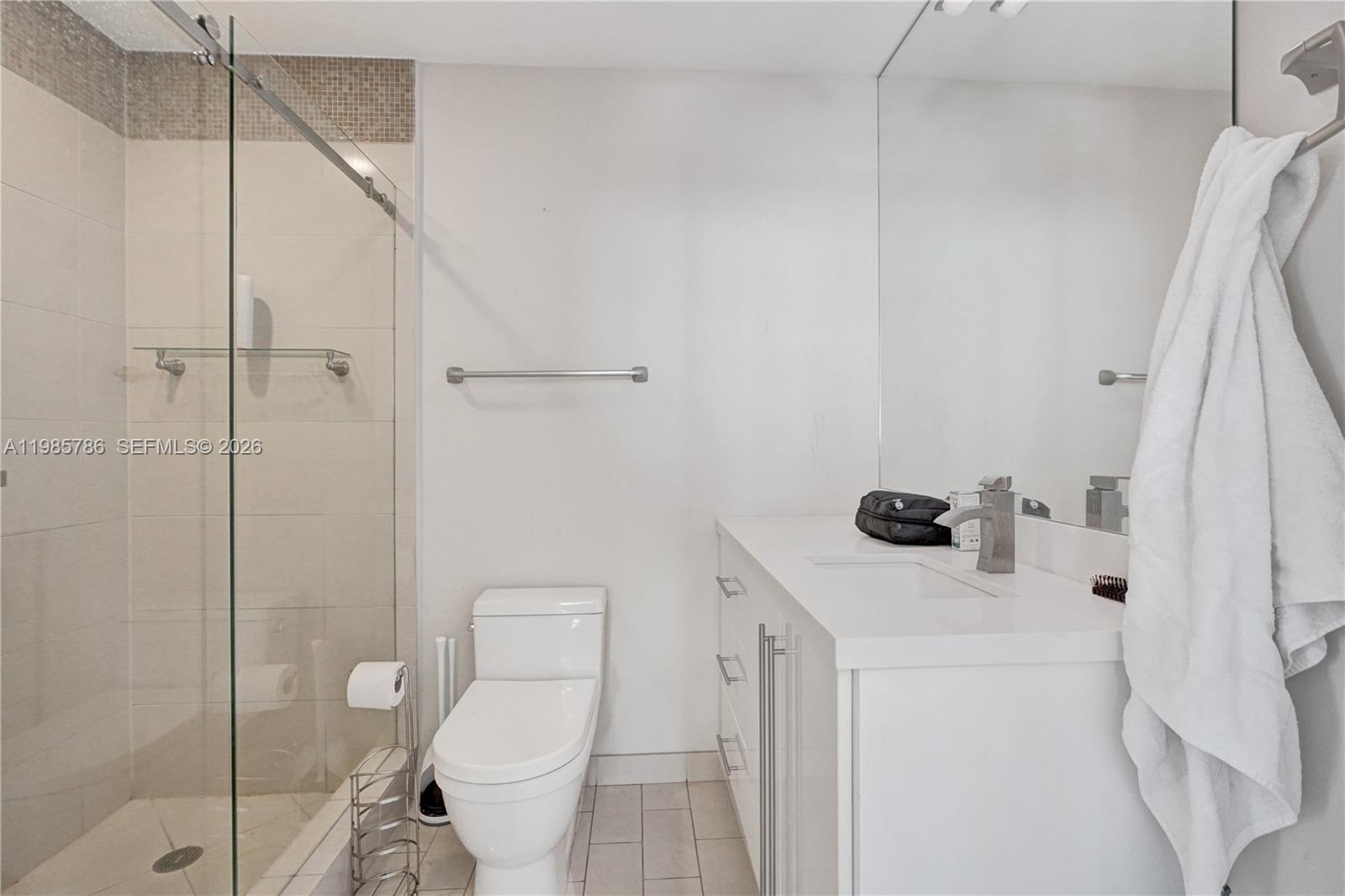 79 Southwest 12th Street, Unit 3412S Miami, FL 33130 - Photo 10 of 37 a bathroom with a sink a toilet and shower