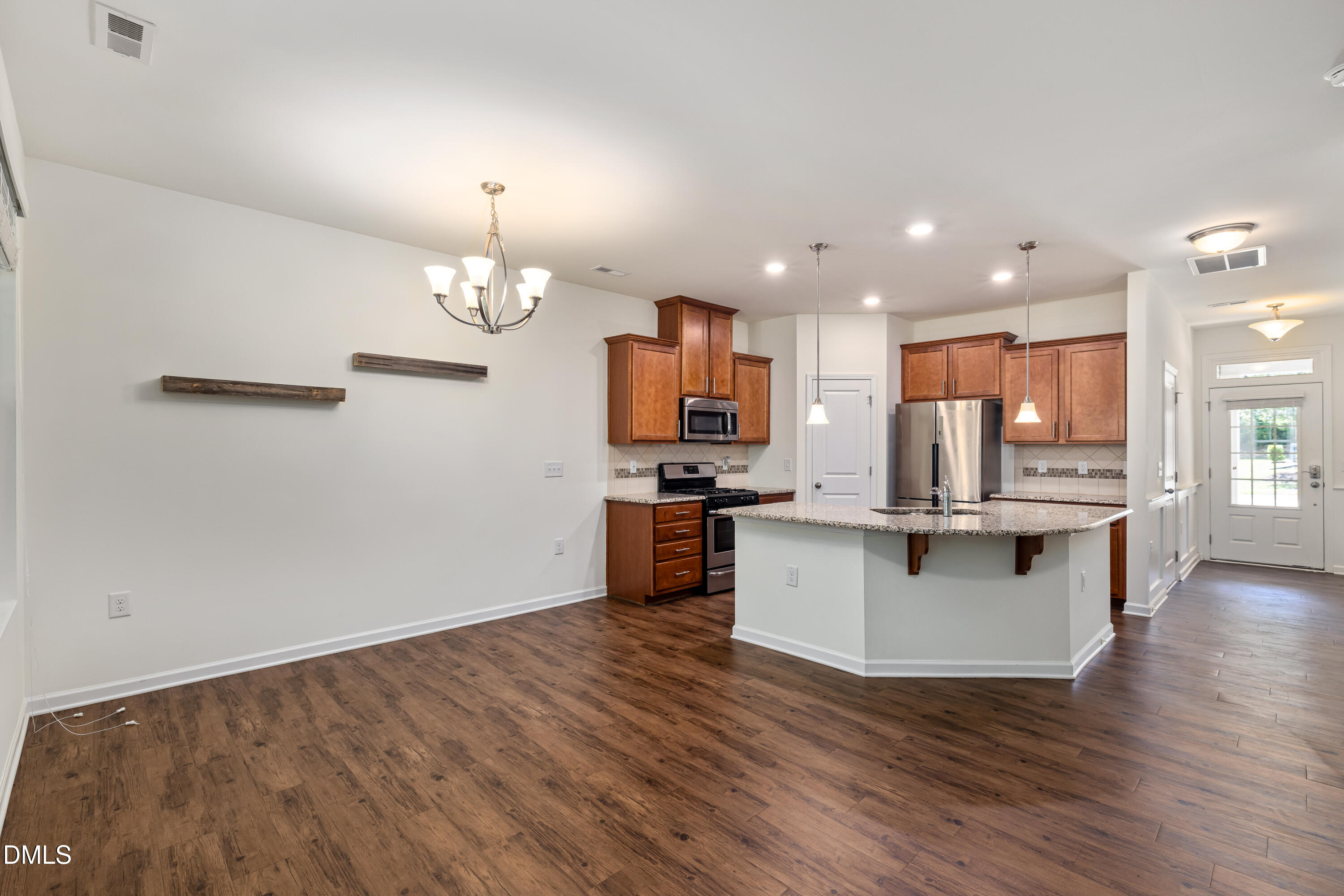 4351 Flintlock Lane Durham, NC 27704 - Photo 13 of 29 a kitchen with stainless steel appliances kitchen island granite countertop a stove and a wooden floors