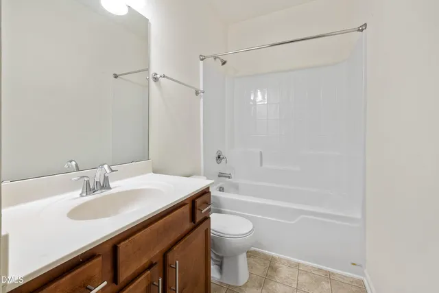 a bathroom with a sink toilet vanity and shower