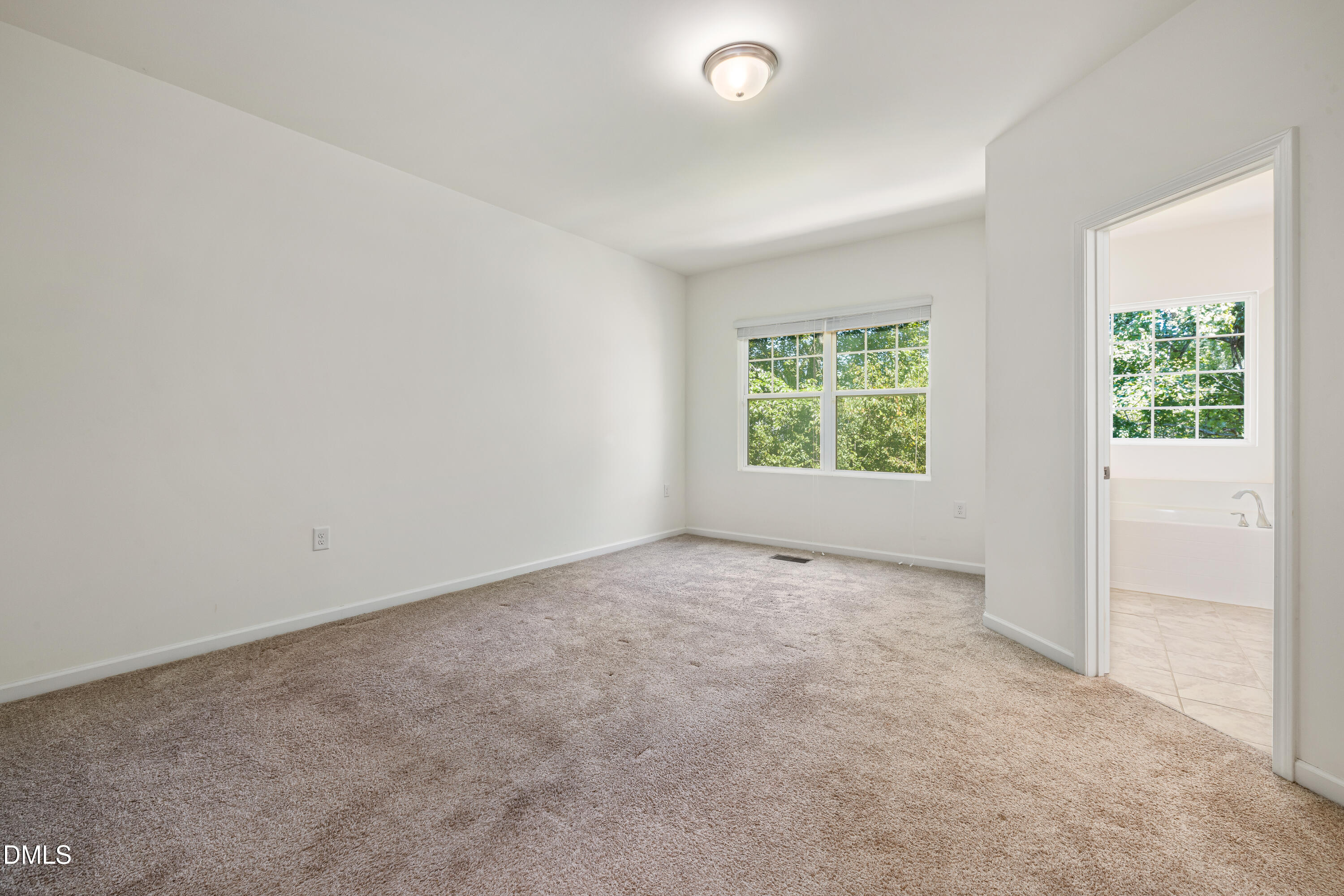 4351 Flintlock Lane Durham, NC 27704 - Photo 21 of 29 an empty room with windows