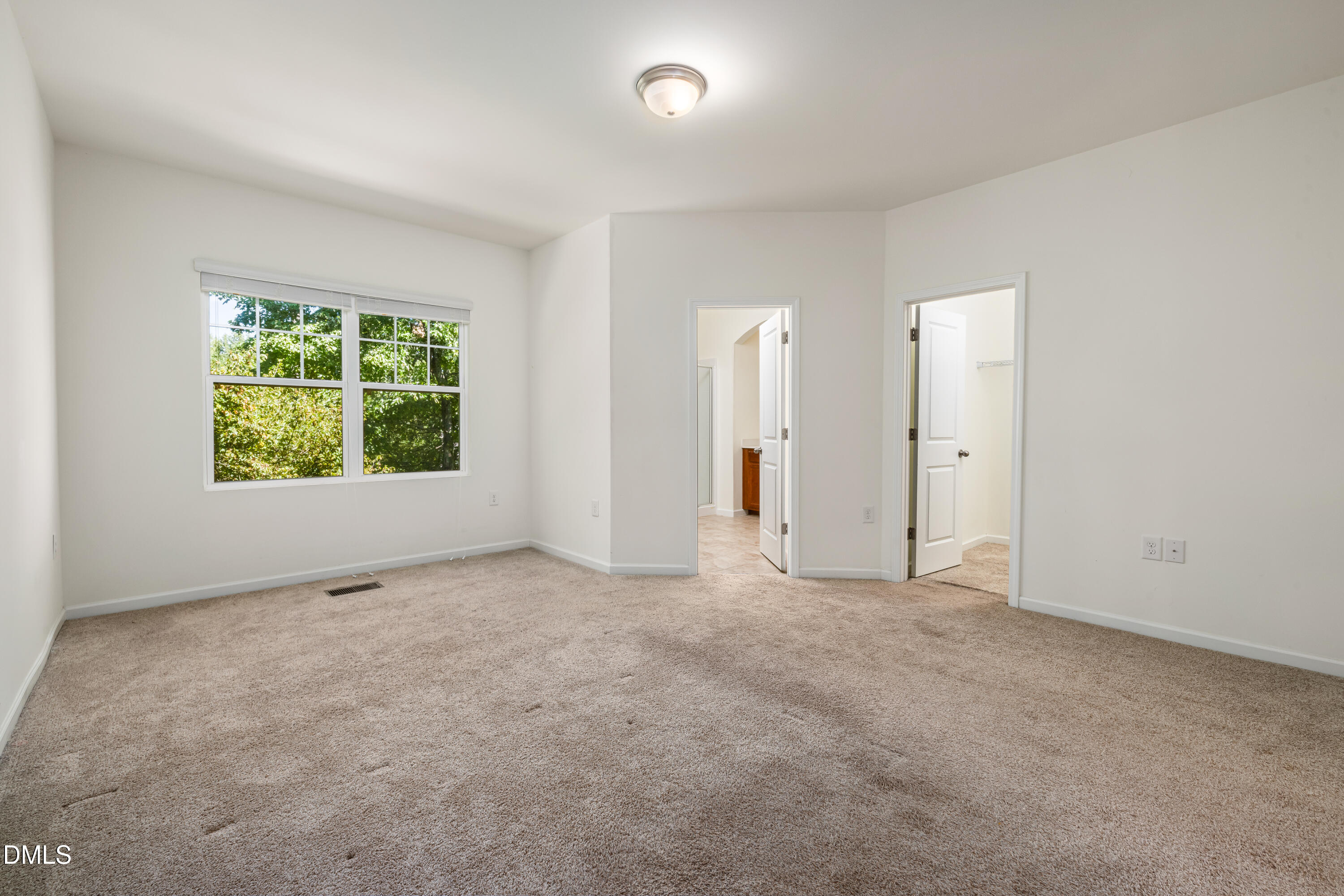4351 Flintlock Lane Durham, NC 27704 - Photo 23 of 29 an empty room with windows and closet