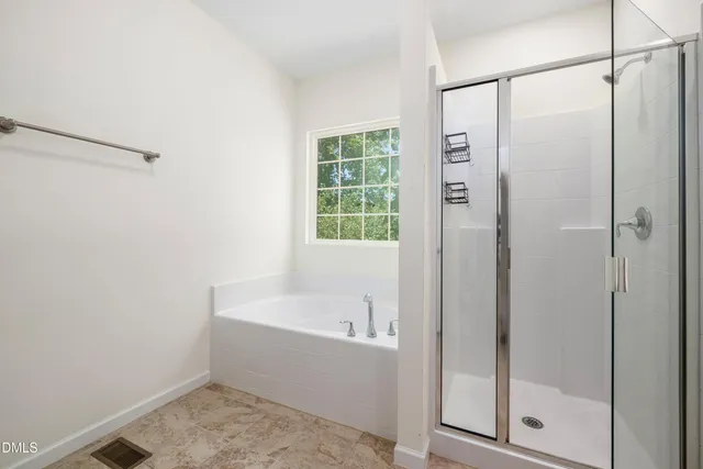 a bathroom with a bathtub and a shower