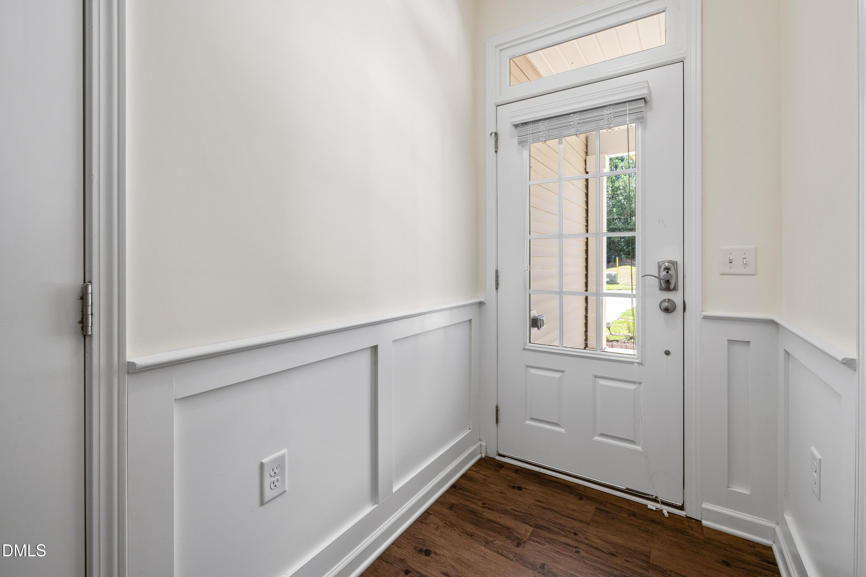 4351 Flintlock Lane Durham, NC 27704 - Photo 4 of 29 a view of an empty room with wooden floor and a window
