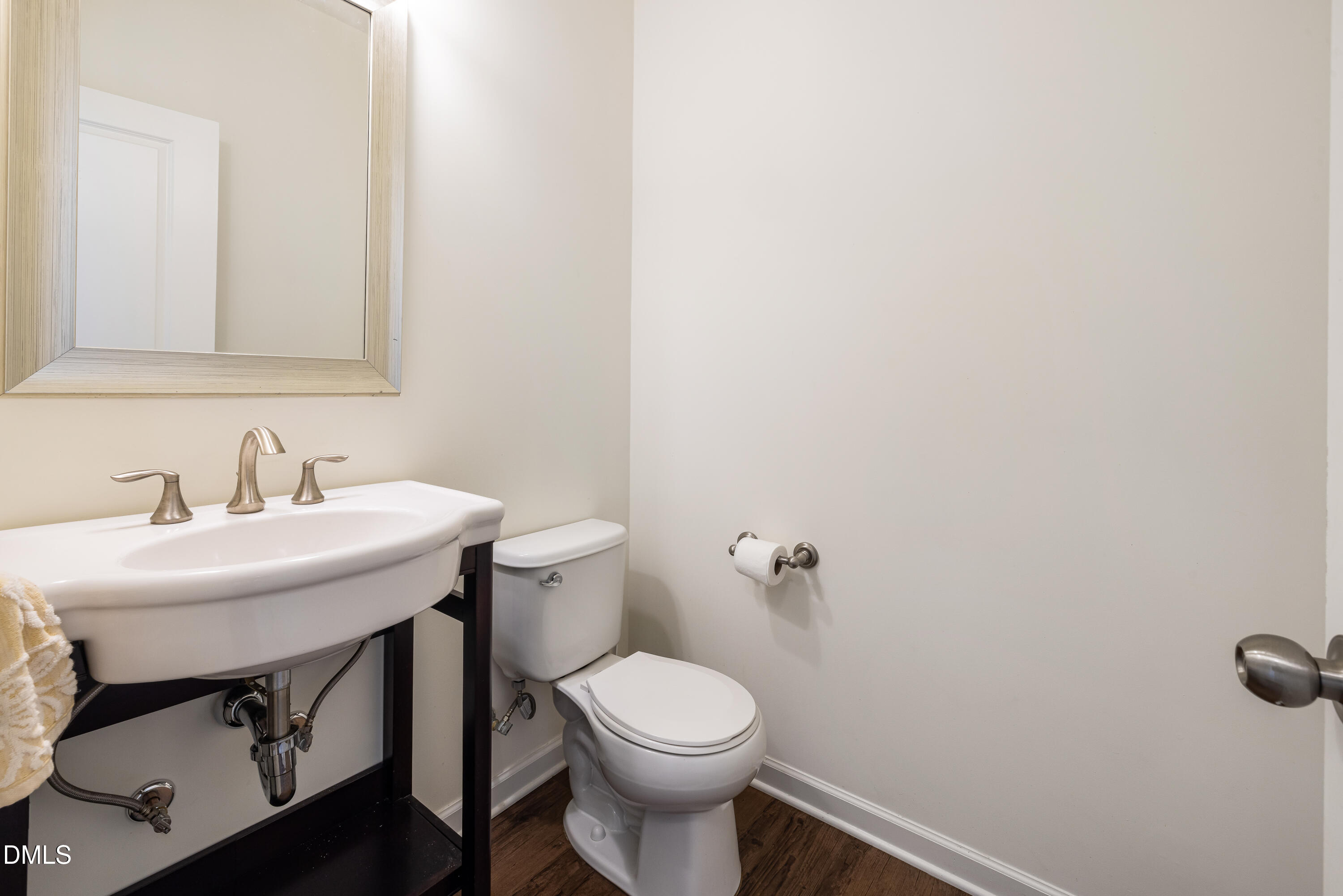 4351 Flintlock Lane Durham, NC 27704 - Photo 5 of 29 a bathroom with a sink a toilet and mirror