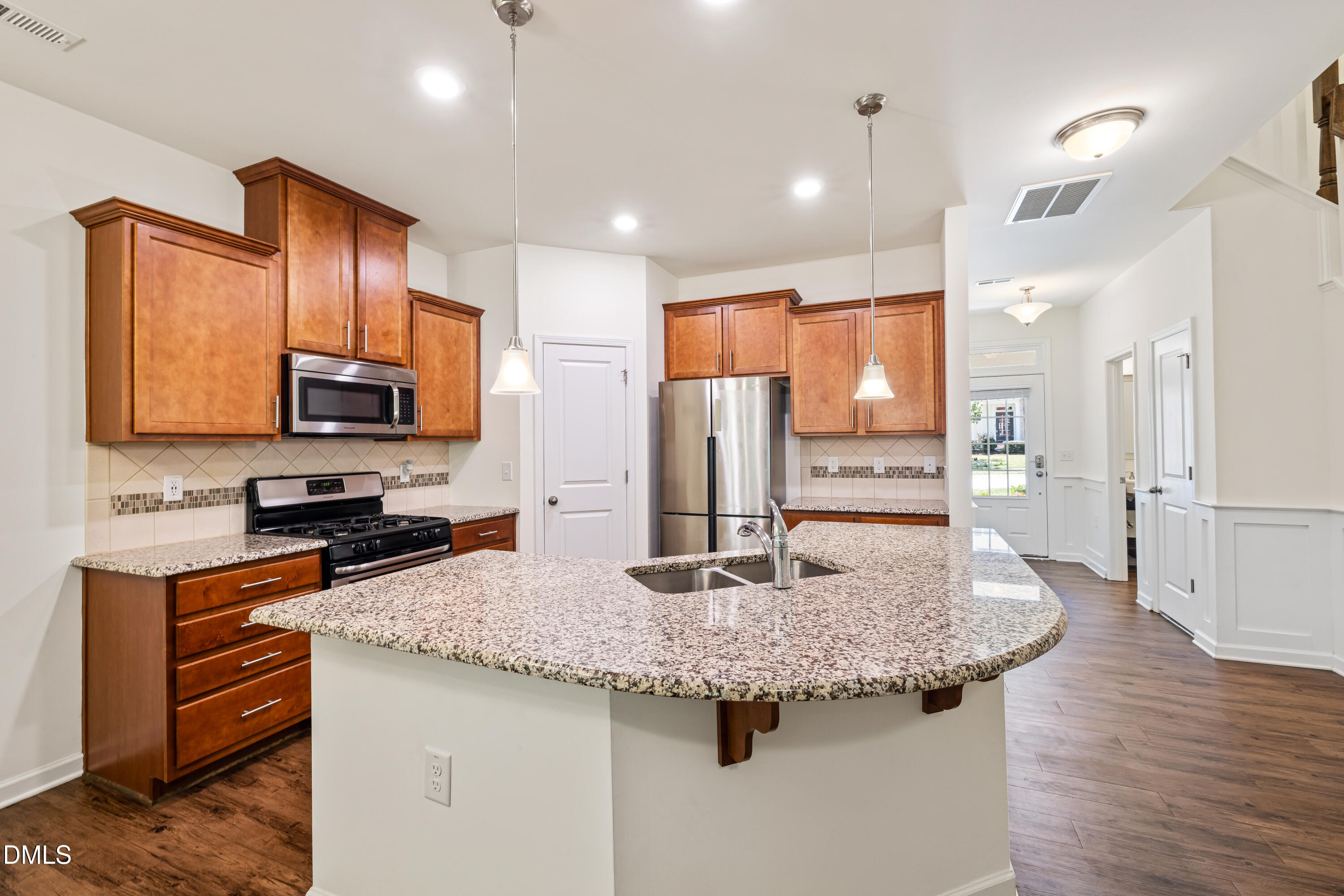 4351 Flintlock Lane Durham, NC 27704 - Photo 10 of 29 a kitchen with stainless steel appliances granite countertop a sink a stove and refrigerator