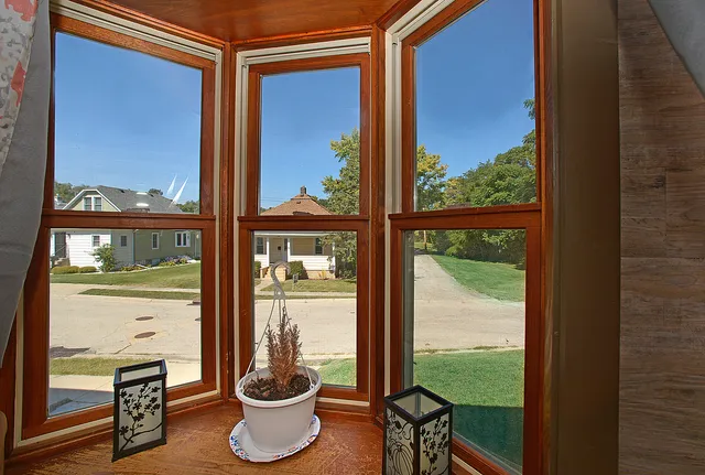 a room with a window and a potted plant on the glass door