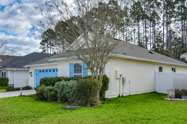 a front view of house with yard and green space
